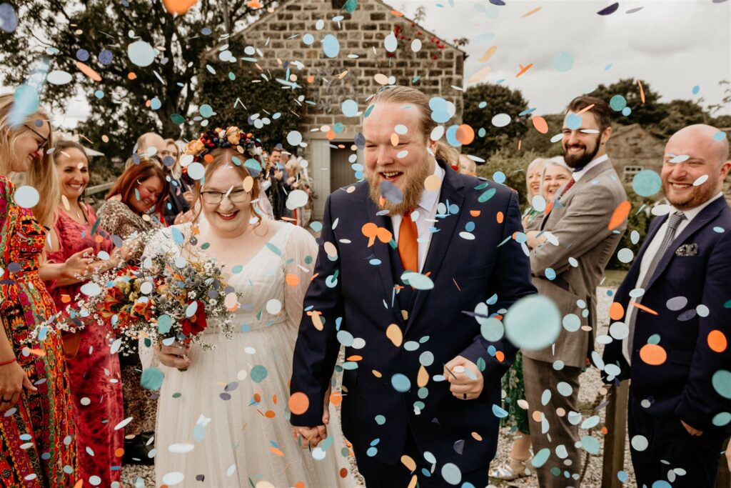 Biodegradable confetti for this wedding looked beautiful as they walked out of their wedding venue