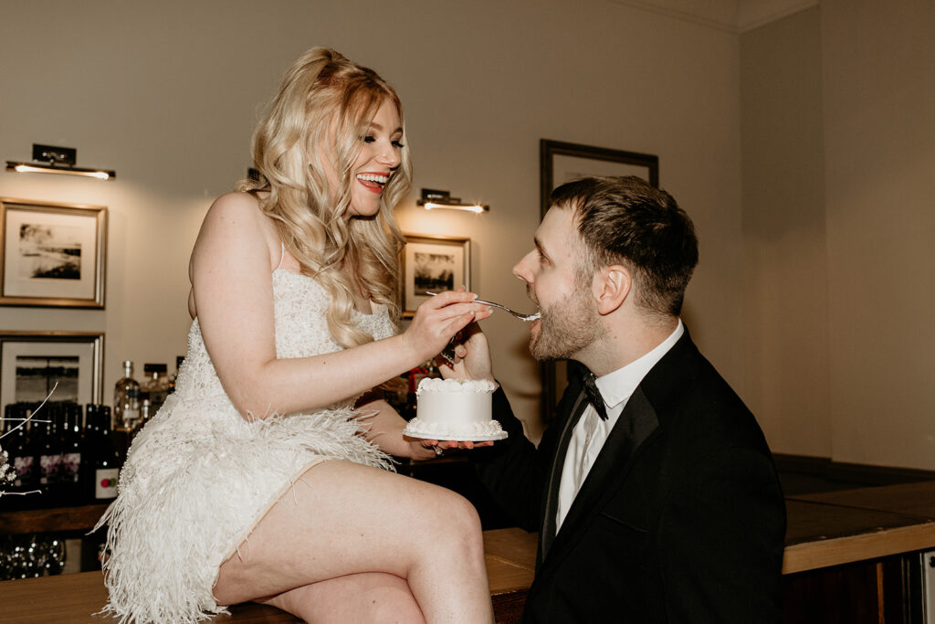 bride feeds groom cake