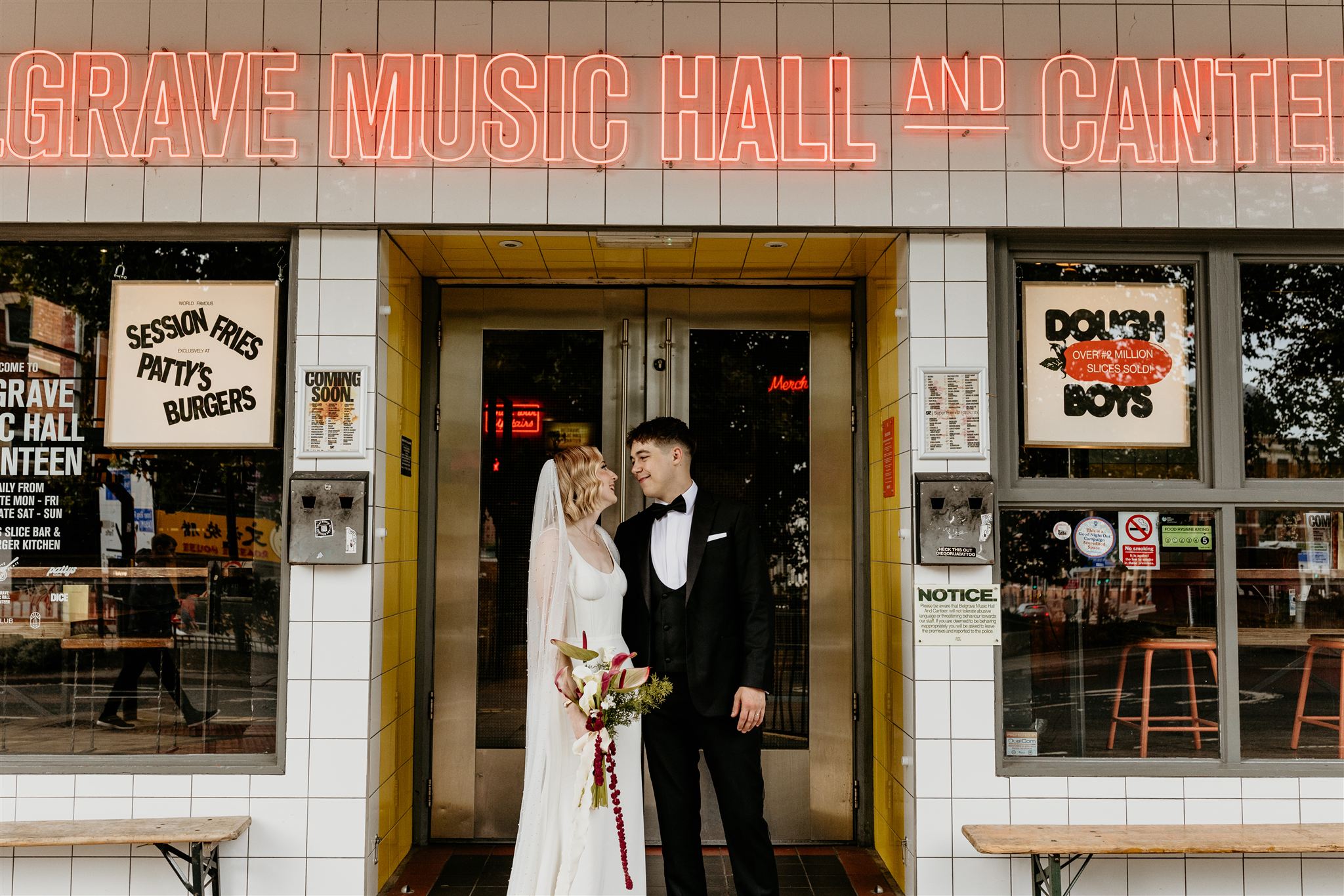 wedding couple stood outside belgrave music hall leeds
