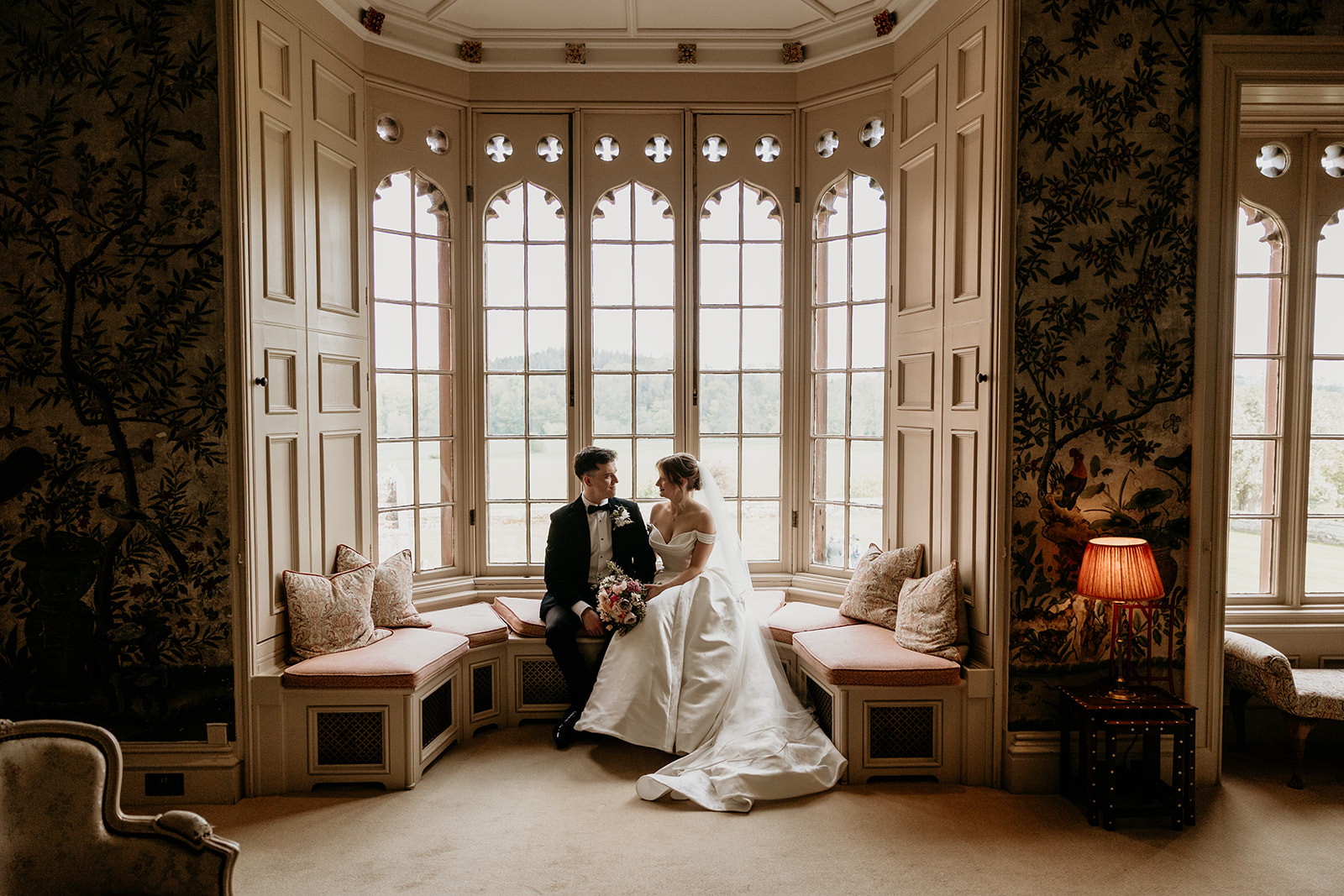 bride and groom sitting in the window of the chinese room at Rose Castle
